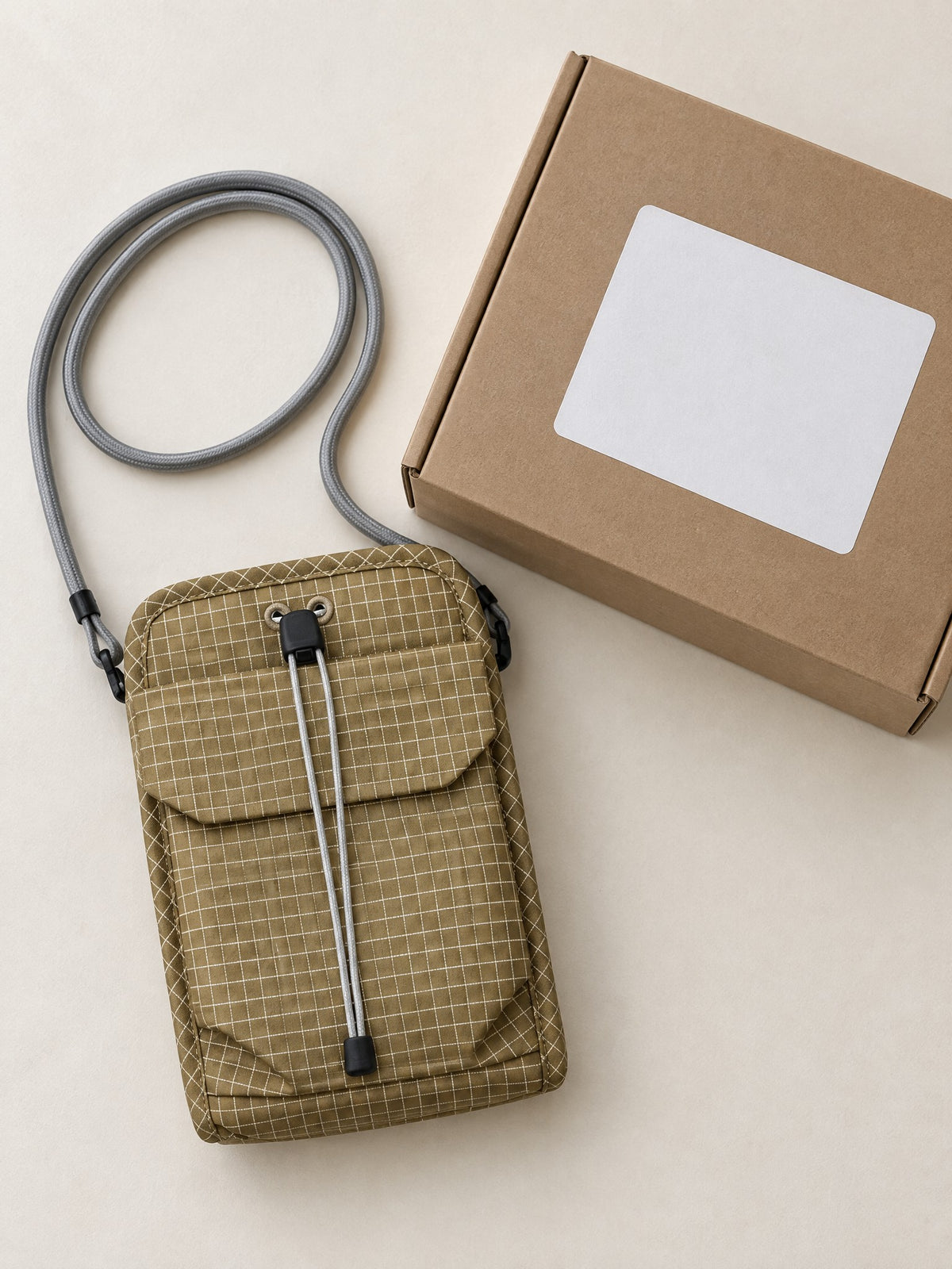 Organizer crossbody bag beside a plain kraft mailer, ready to ship