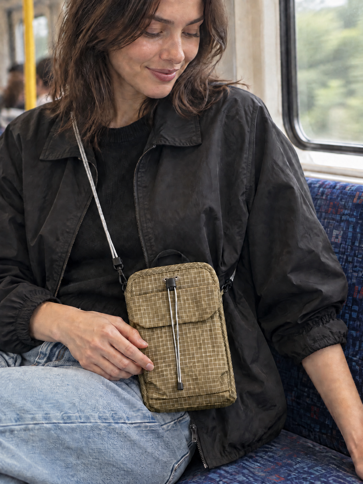 Crossbody phone bag worn across the body in Tan — grid-ripstop everyday carry organizer