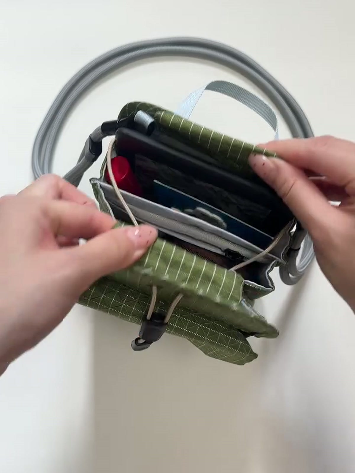 FURL Organizer Crossbody — loaded, 3:4 still from the product video