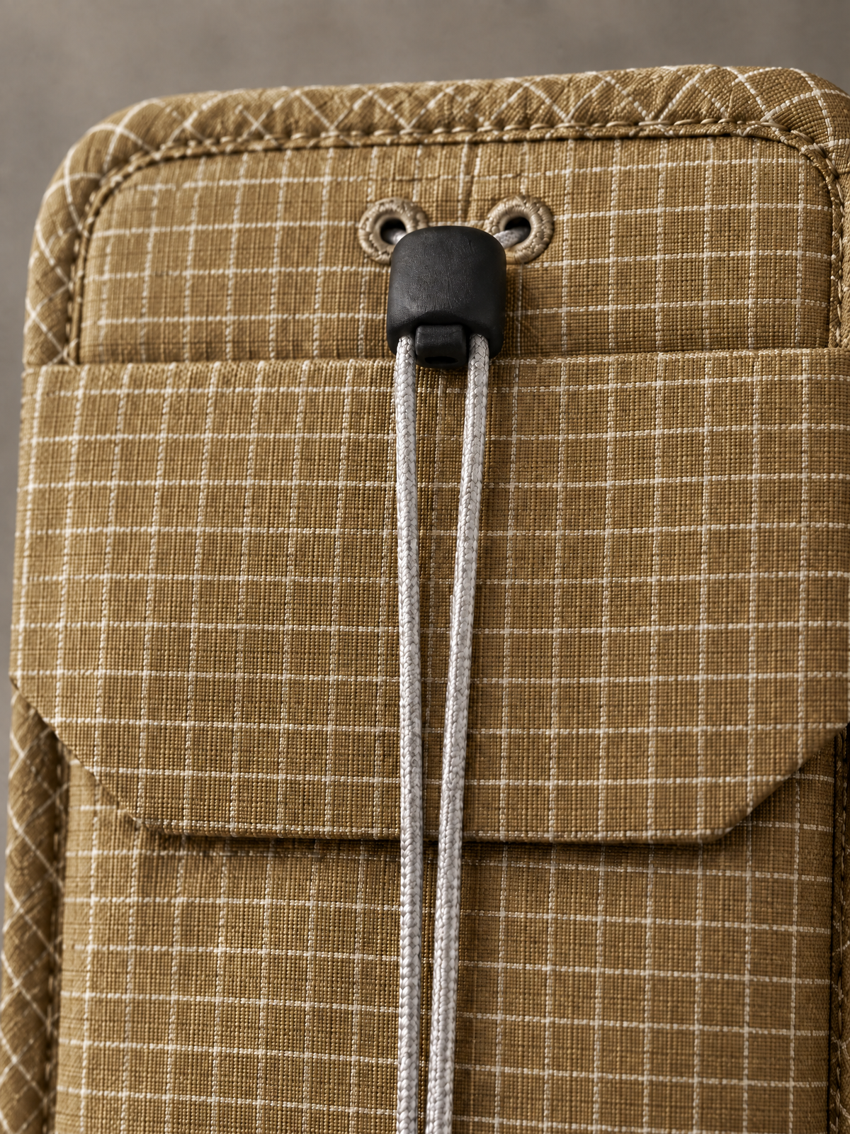 Close-up of the flap and cord lock on the Tan Pocket Sling
